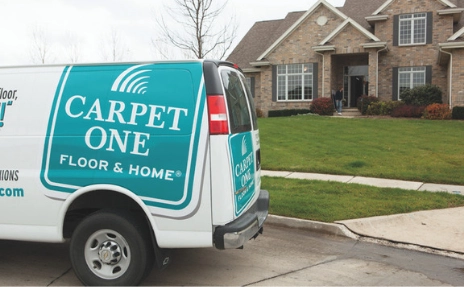 a carpet one van parked in front of a house